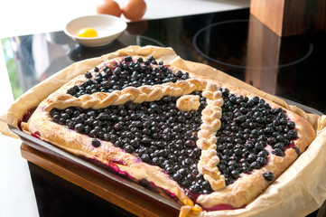 Fresh homemade blueberry pie from yeast dough. Closeup indoors i