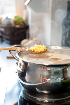 Making pea soup. Saucepan and wooden spoon with pea.