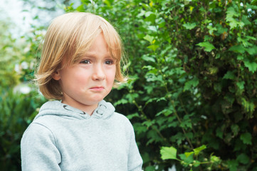 Close up portrait of a sad little boy