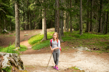 Little hiker girl in forest. Photo from Champex-Lac, Valais, swiss Alps