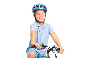 Little boy with blue helmet sitting on his bicycle and looking a