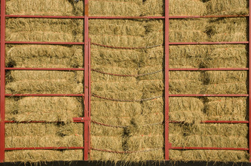 Hay bales piled within a cart