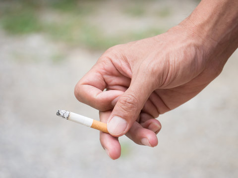 Hand Holding Cigarette While Smoking