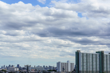 Fototapeta na wymiar kyline under blue sky with scenic fluffy clouds