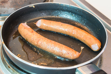 Sausages on a pan with induction