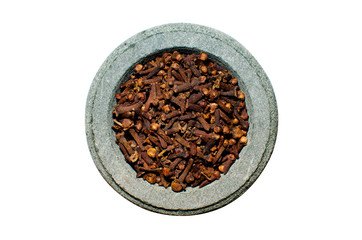 Cloves in stone spice grinder, isolated on white