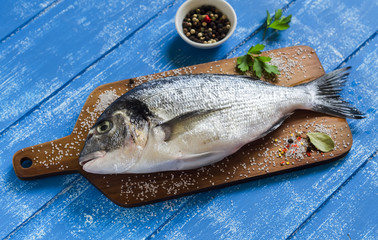 fresh Dorado fish on a blue wooden background