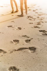 people foot prints on the beach sand