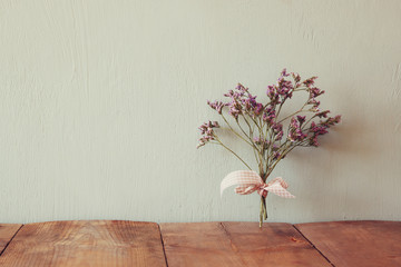 bouquet of dried flowers rope against wooden background
