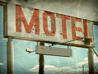 aged and worn vintage photo of neon motel sign
