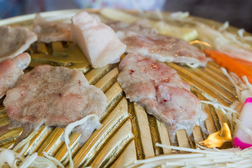 Fresh pork slices on oven.