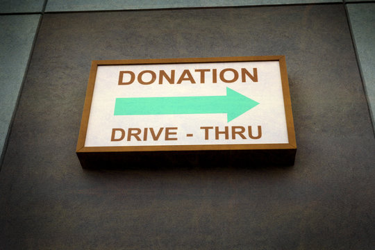aged and worn vintage photo of donations sign