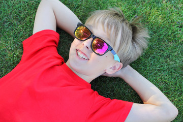 boy lying grass boy smiling