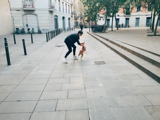 woman isnplaying and dancing with her dog