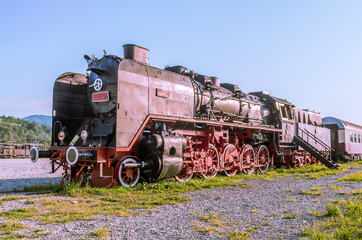 Naklejka premium Old black steam powered railway train. Restored old vintage steam train built at Resita, Romania.