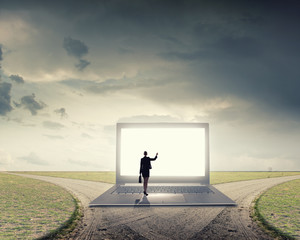 Woman standing on big laptop