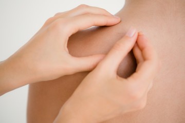 Pretty brunette enjoying a massage on shoulders 