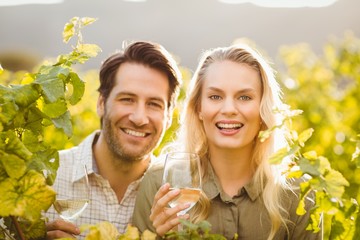Young happy couple holding glasses of wine