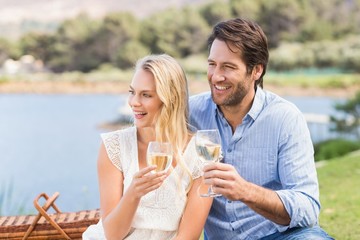 Couple on date toasting with glass of white wine
