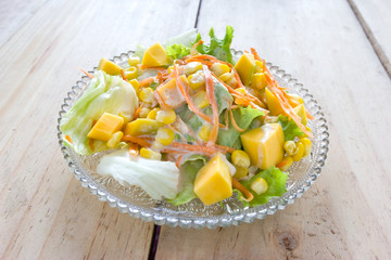 salad on crystal dish,wood background