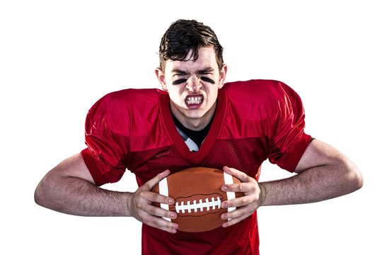 American football player crushing a ball