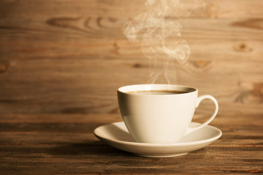 Steaming hot coffee in white mug