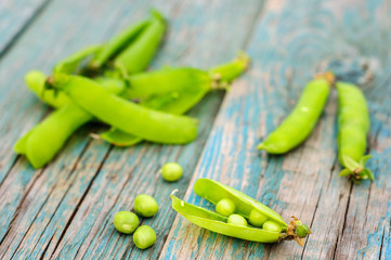 Ripe green peas in pod on shabby background