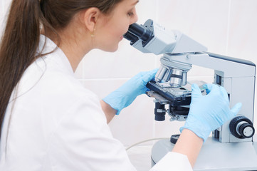 medical researcher working with microscope