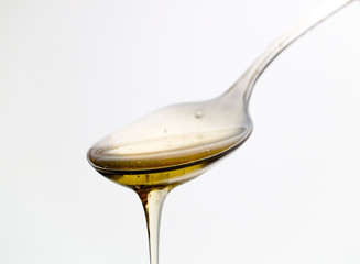 Spoon with liquid honey