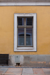 Old window of a building on the yellow wall in Germany.