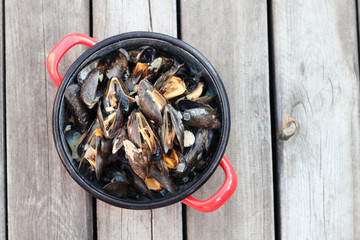 Steamed fresh mussels with wine in a pot.