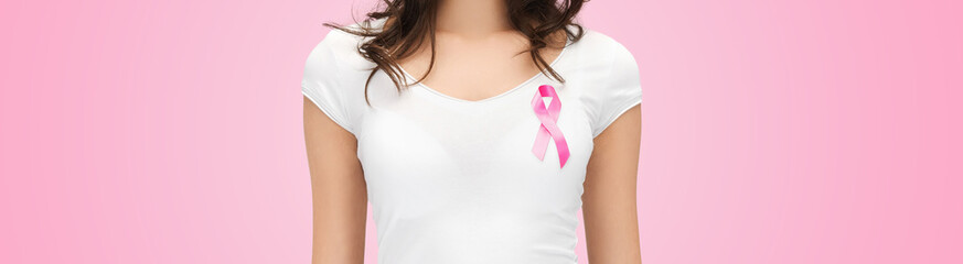smiling young woman with cancer awareness ribbon