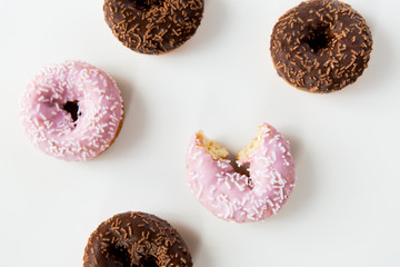 close up of glazed donuts pile over white