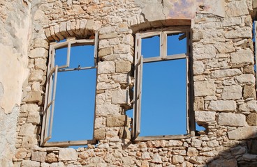 Looking through the windows of a derelict building at Emborio on the Greek island of Halki.