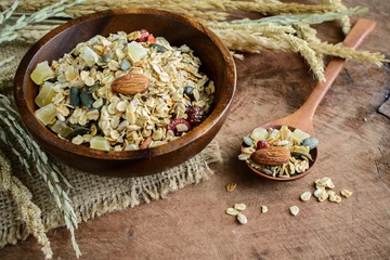 Selbstklebende Fototapeten Oat and whole wheat grains flake in wooden bowl on wooden table © Kittiphan