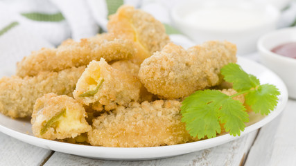 Stuffed Jalapenos - green chilies filled with cheese, breaded and deep fried.