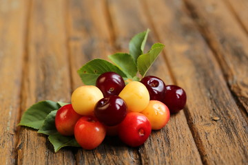 Fresh sweet cherries on old wooden background retro vintage