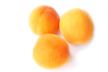 Three apricots isolated on a white background farm organic product