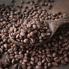 wooden spoon with coffee beans
