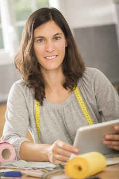 young seamstress with a tablet