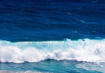 Ocean waves and surf in sunlight