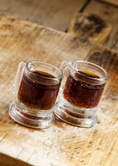 Dark beer in an old-fashioned cups, selective focus