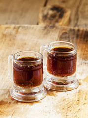 Dark beer in an old-fashioned cups, selective focus