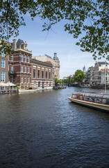 Fototapeta na wymiar Amsterdam canal / river boat scene