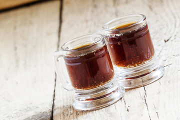 Dark beer in an old-fashioned cups, selective focus