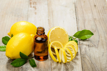 lemon essential oil and lemon fruit on the wooden board, (taken with tilt shift lens)