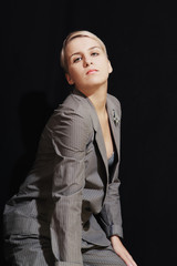 Young woman in suit and bra