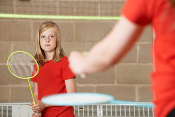 Two Girl Playing Badminton In School Gym