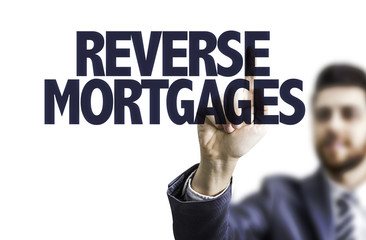 Business man pointing the text: Reverse Mortgages