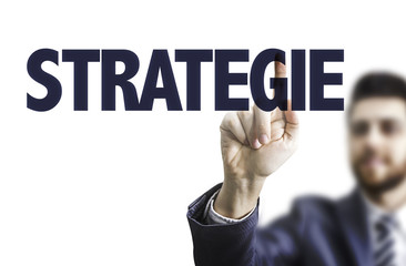 Business man pointing the text: Strategy (in German)